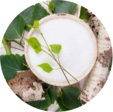 Seller illustration showing a bowl of white material and leaves beside xylitol copy; composition not visually verified